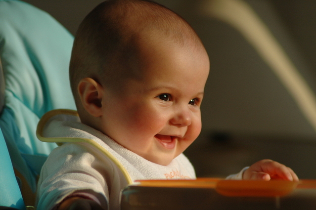 smiling baby in a high chair